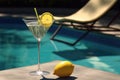 martini glass with a twist of lemon by a sun lounger Royalty Free Stock Photo