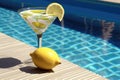 martini glass with a twist of lemon by a sun lounger Royalty Free Stock Photo
