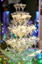 Martini glasses in the form of a cascade or pyramid lit light at the wedding party