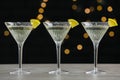 Martini glasses of refreshing cocktails with lemon slices on light grey table Royalty Free Stock Photo