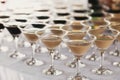 Martini rows on table at wedding reception. Cocktails and red and white martini in glasses at alcohol bar at wedding or christmas