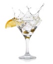 Martini splash with lemon and green olives in a cocktail glass Royalty Free Stock Photo
