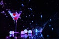 Martini splashing out of glass near ice on black background Royalty Free Stock Photo