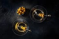 Martini, two glasses with spicy olives, on a black background Royalty Free Stock Photo