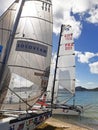 Catamaran sails under tropical blue skies of the French Antilles. Head sails of regatta sailboats