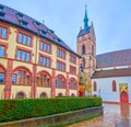 Martinskirchplatz square with Martin`s Church and building of State Archives of Basel-stadt with colorful fountain, Basel,