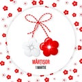 Martisor, a red and white symbol of spring on the background of flowers. Traditional spring holiday in Romania and Moldova.