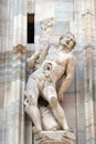 Martyrdom of Saint Erasmus, statue on the Milan Cathedral Royalty Free Stock Photo