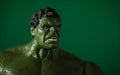 Marvel Superhero toy editorial on the green background with copy space. The Hulk is huge and angry. Avenger in the action clench Royalty Free Stock Photo