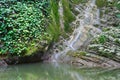 Marvellous cliffs covered with ivy and moss with flowing waterfall Royalty Free Stock Photo