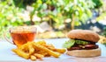 Marvelous Homemade beef burger with mushrooms, micro greens, red onion, beet sauce on wooden board. Royalty Free Stock Photo