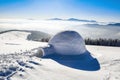 Marvelous huge white snowy hut, igloo the house of isolated tourist is standing on high mountain far away from the human eye. Royalty Free Stock Photo
