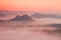 Marvelous red daybreak. Misty daybreak in a beautiful hills. Peaks of hills are sticking out from foggy background, the fog is red