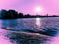 Sandy beach and water at Sundown over the riverside of the river Rhein in Cologne with sky, clouds and bridge Royalty Free Stock Photo