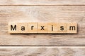 Marxism word written on wood block. marxism text on table, concept