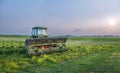 Maryland farm with tractor and tiller in a field at sunset