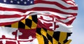 Maryland state flag waving in the wind with blurred US national flag Royalty Free Stock Photo