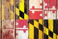 Maryland US state national flag on a gray wooden boards background on the day of independence in different colors of blue red and Royalty Free Stock Photo