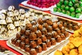 Marzipan covered with dark chocolate glaze, confectionery counter with selective focus