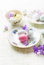 Marzipan Easter eggs on vintage plates and in cups Royalty Free Stock Photo