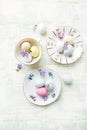 Marzipan Easter eggs on vintage plates and in cups Royalty Free Stock Photo