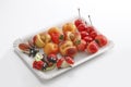 Marzipan, ladybird, may bug, peaches, strawberries, cherries on paper plate