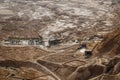 Masada ancient place as touristic attraction with interesting geological surrounding and palm trees along the road in