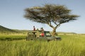 Masai scouts and tourist look for animals from a Landcruiser during a game drive at the Lewa Wildlife Conservancy in North Kenya, Royalty Free Stock Photo