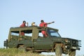 Masai scouts and tourist look for animals from a Landcruiser during a game drive at the Lewa Wildlife Conservancy in North Kenya,