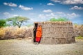 Masai with traditional hut. Tanzania. Royalty Free Stock Photo