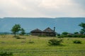 Masai village near Ngorongoro crater and Mto Wa Mbu. Small Masai huts in African savanna, Tanzania Royalty Free Stock Photo