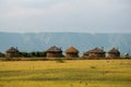 Masai village near Ngorongoro crater and Mto Wa Mbu. Small Masai huts in African savanna, Tanzania Royalty Free Stock Photo