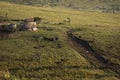 Masai village in Ngorongoro crater. Small Masai huts in African savanna, Tanzania Royalty Free Stock Photo
