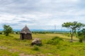Masai village with small huts in African savanna, Tanzania Royalty Free Stock Photo