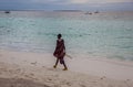 Masai walking along the shore
