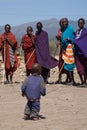 Masai warriors looking at masai kid