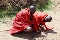 Masai warriors trying to generate fire through old Royalty Free Stock Photo