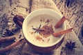 Masala chai tea with spices and star Anise, cinnamon stick, peppercorns, on sack and wooden background