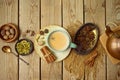 Masala chai tea traditional indian drink with milk and spices on wooden backgraound. Top view from above