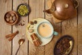 Masala chai tea traditional indian drink  with milk and spices on wooden background. Top view from above Royalty Free Stock Photo