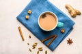 Traditional Indian masala tea chai with milk and spices on napkin on white background with ingredients above Royalty Free Stock Photo