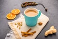 Traditional Indian masala tea chai with milk and spices on napkin on dark stone background with ingredients above Royalty Free Stock Photo