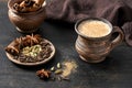 Masala pulled tea chai latte hot Indian sweet milk spiced drink, cinnamon stick, cloves, fresh spices and herbs blend Royalty Free Stock Photo