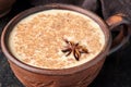 Masala tea chai latte traditional homemade warm Indian sweet milk spiced drink, ginger, fresh spices blend