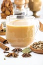 Masala tea in a glass cup and a natural mixture for its preparation - star anise, cinnamon sticks, cardamom, bay leaf, pepper Royalty Free Stock Photo