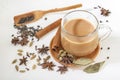 Masala tea in a glass cup and a natural mixture for its preparation - star anise, cinnamon sticks, cardamom, bay leaf, Royalty Free Stock Photo
