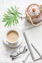 Masala tea, teapot, notepad, glasses, pen, green flower leaf on white background, top view. Morning inspiration planning.