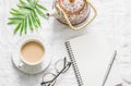 Masala tea, teapot, notepad, glasses, pen, green flower leaf on white background, top view. Morning inspiration planning.