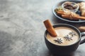 Masala tea. Traditional indian chai in black cup with spiced on grey background. With copy space. With copy space