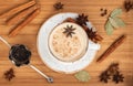 Masala tea. Traditional Indian drink with spices and milk on a wooden background close up. Top view, flat lay Royalty Free Stock Photo